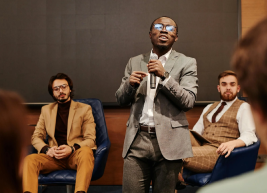 image of an individual addressing a group of people